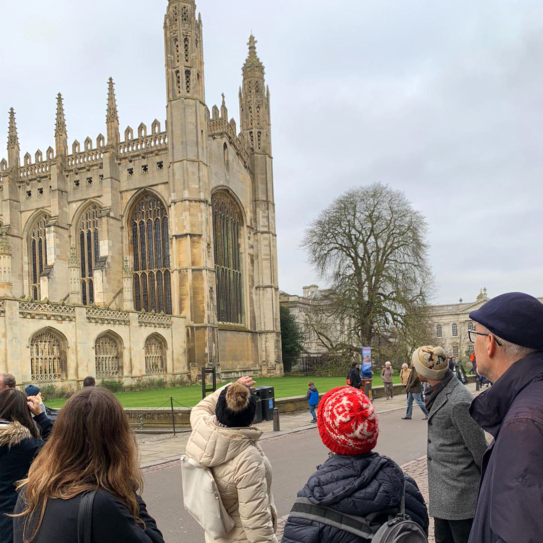 A tour guide and her tour group in front of King's College Chapel in the city of Cambridge.